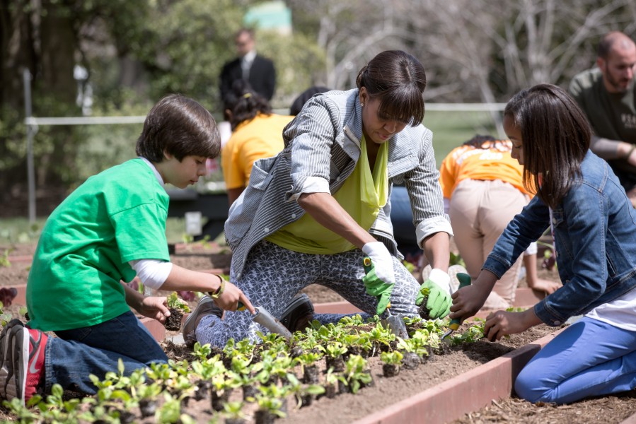 First Lady Michelle Obama and students from around the country participate in the White House Kitchen Garden spring planting on the South Lawn of the White House, April 4, 2013