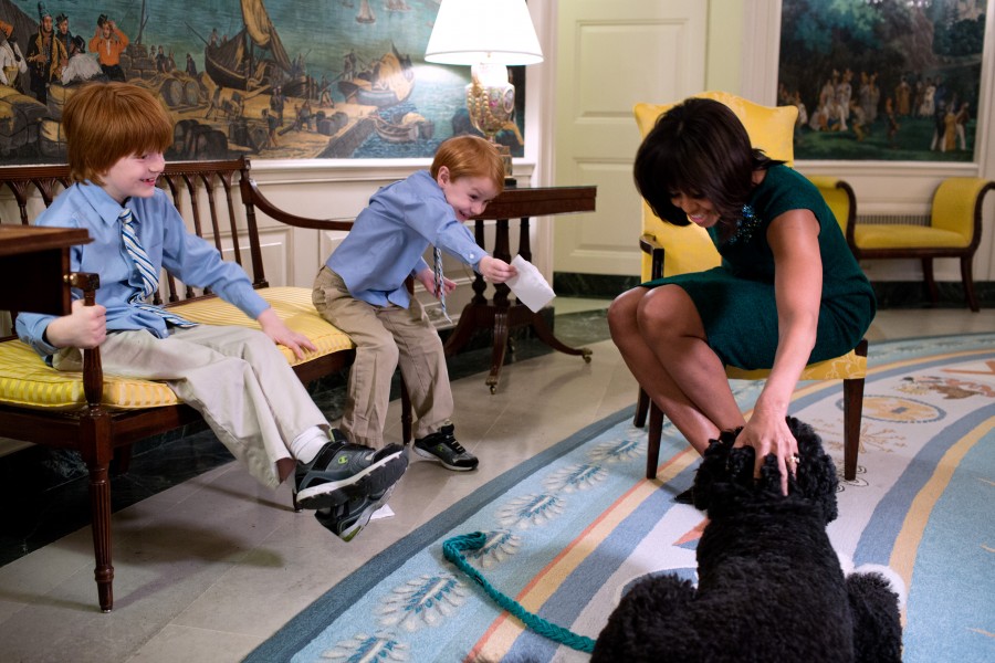 Michelle Obama pets Bo during a taping for 