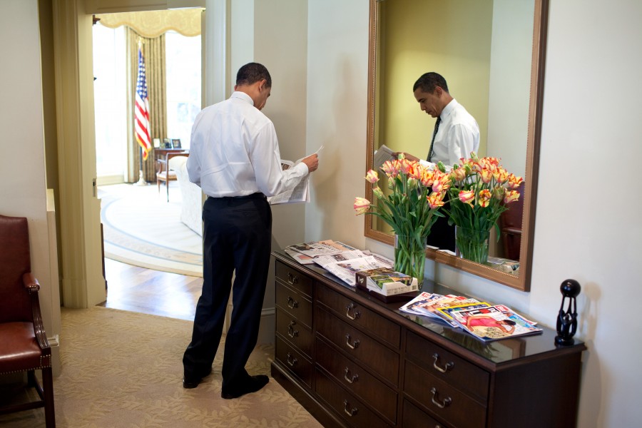 Obama reading newspaper