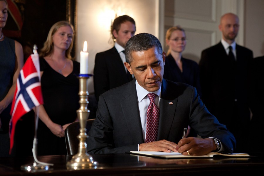 President Barack Obama signs the condolence book during a visit to the Norwegian ambassador's residence in Washington, D.C., July 26, 2011