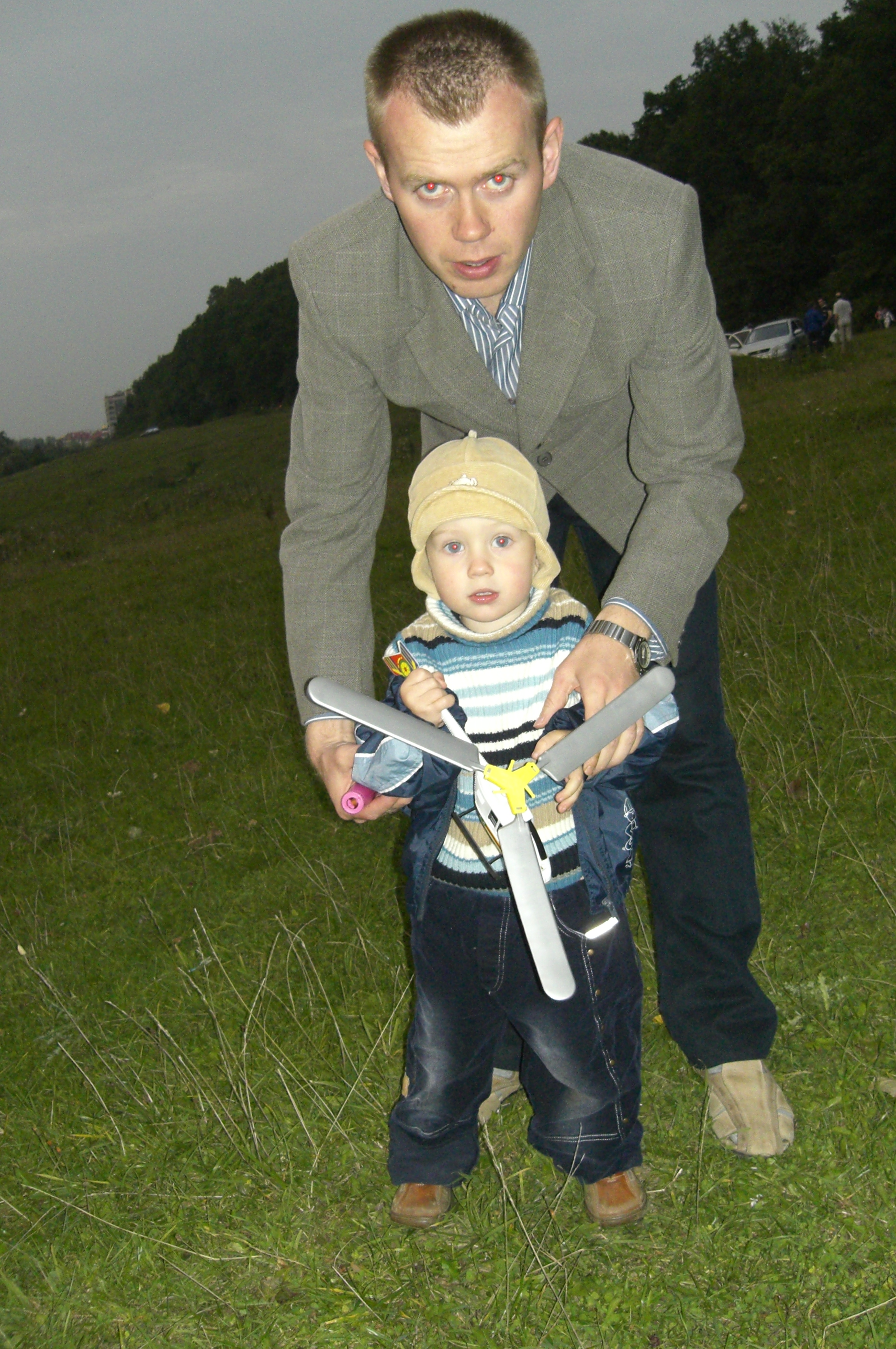 Father, son, and plastic helicopter toy.
