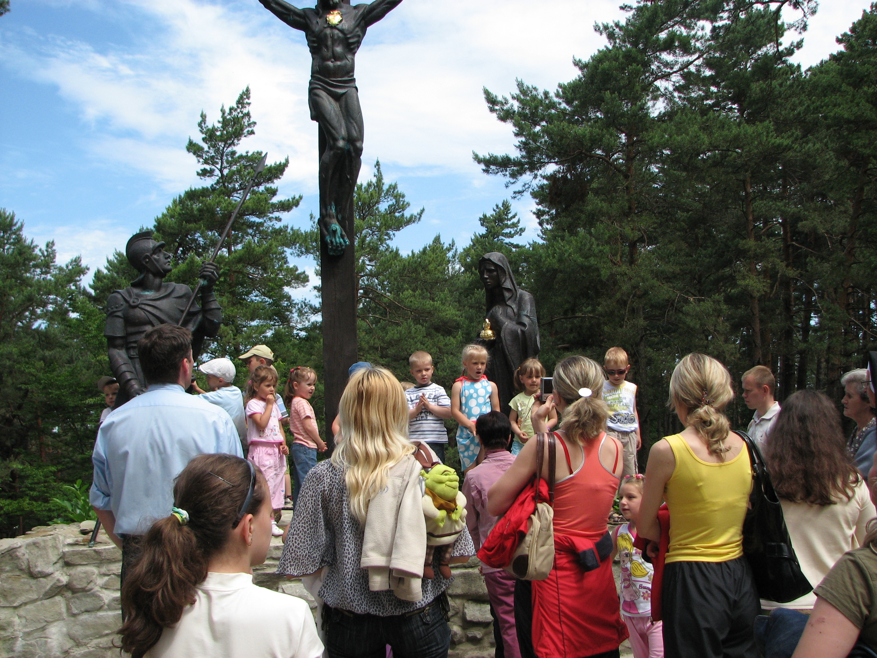 Catholic kids with parents during a pilgrimage to a sanctuary