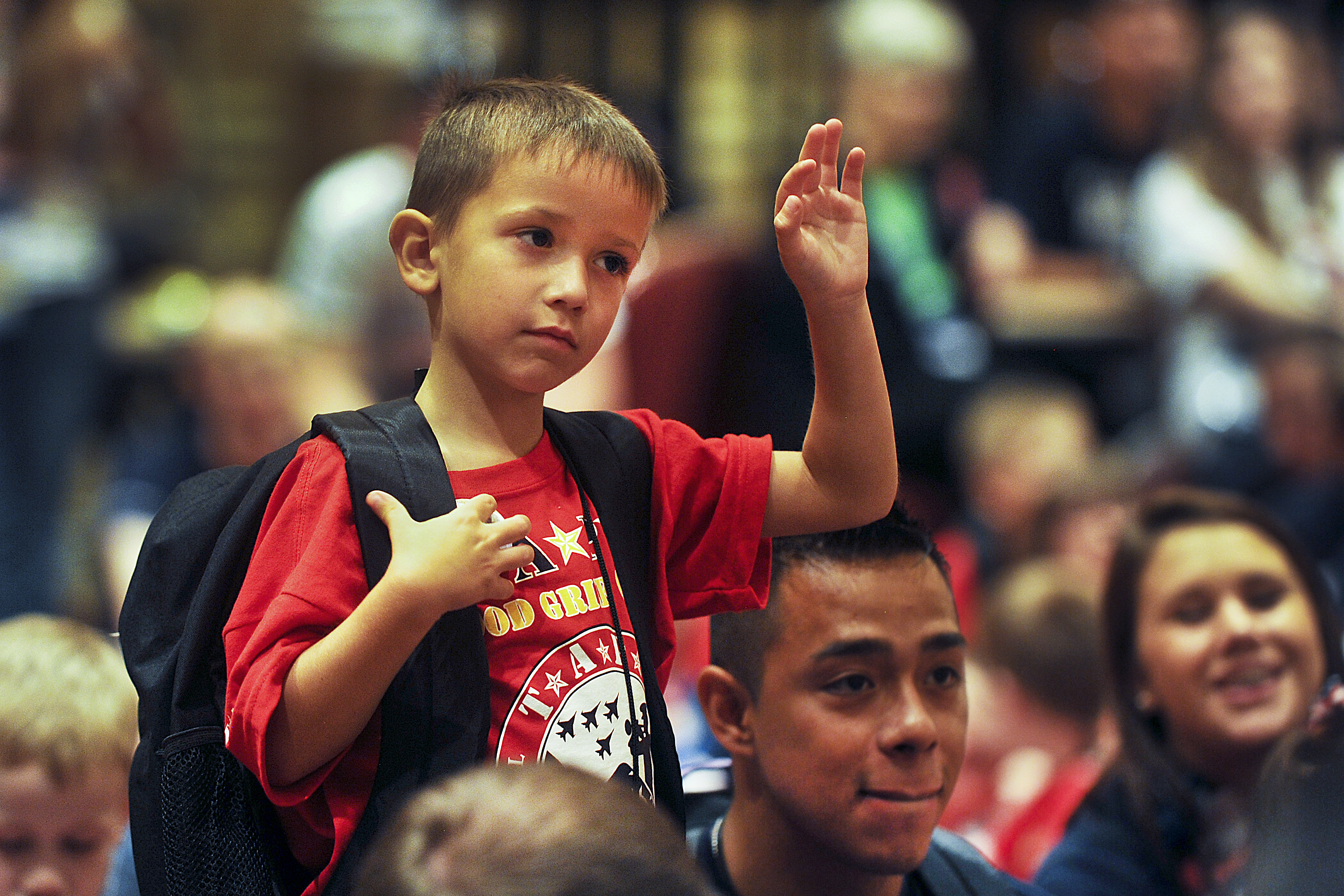 A child with the TAPS organization raises his hand to ask a question to Gen. Martin E. Dempsey, May 2012