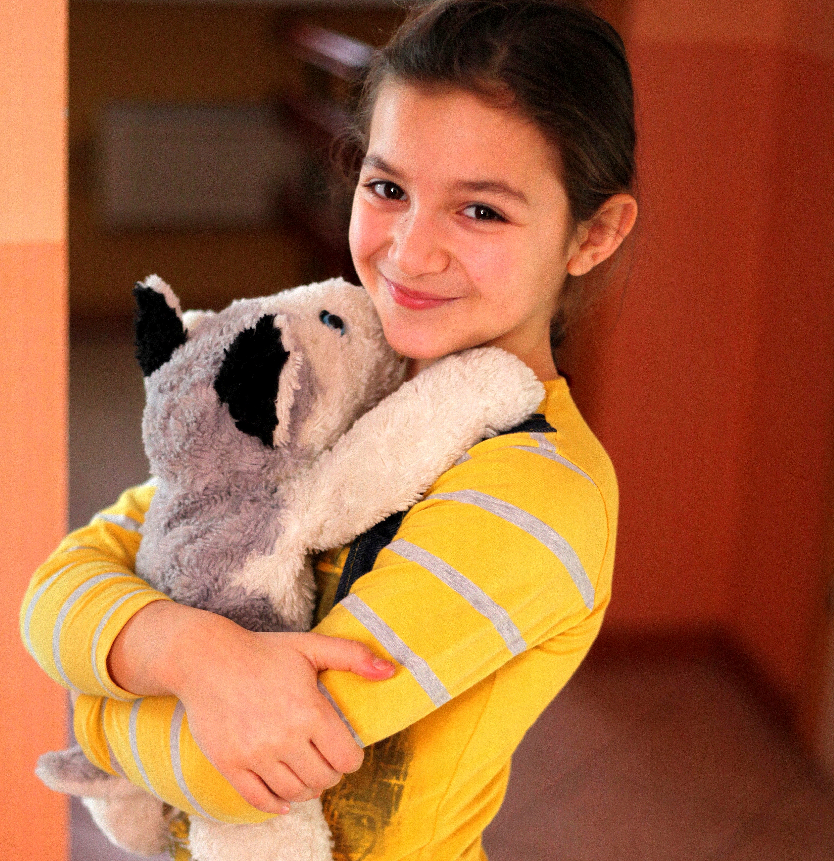 a cute brunette Catholic child girl in the Church's premises