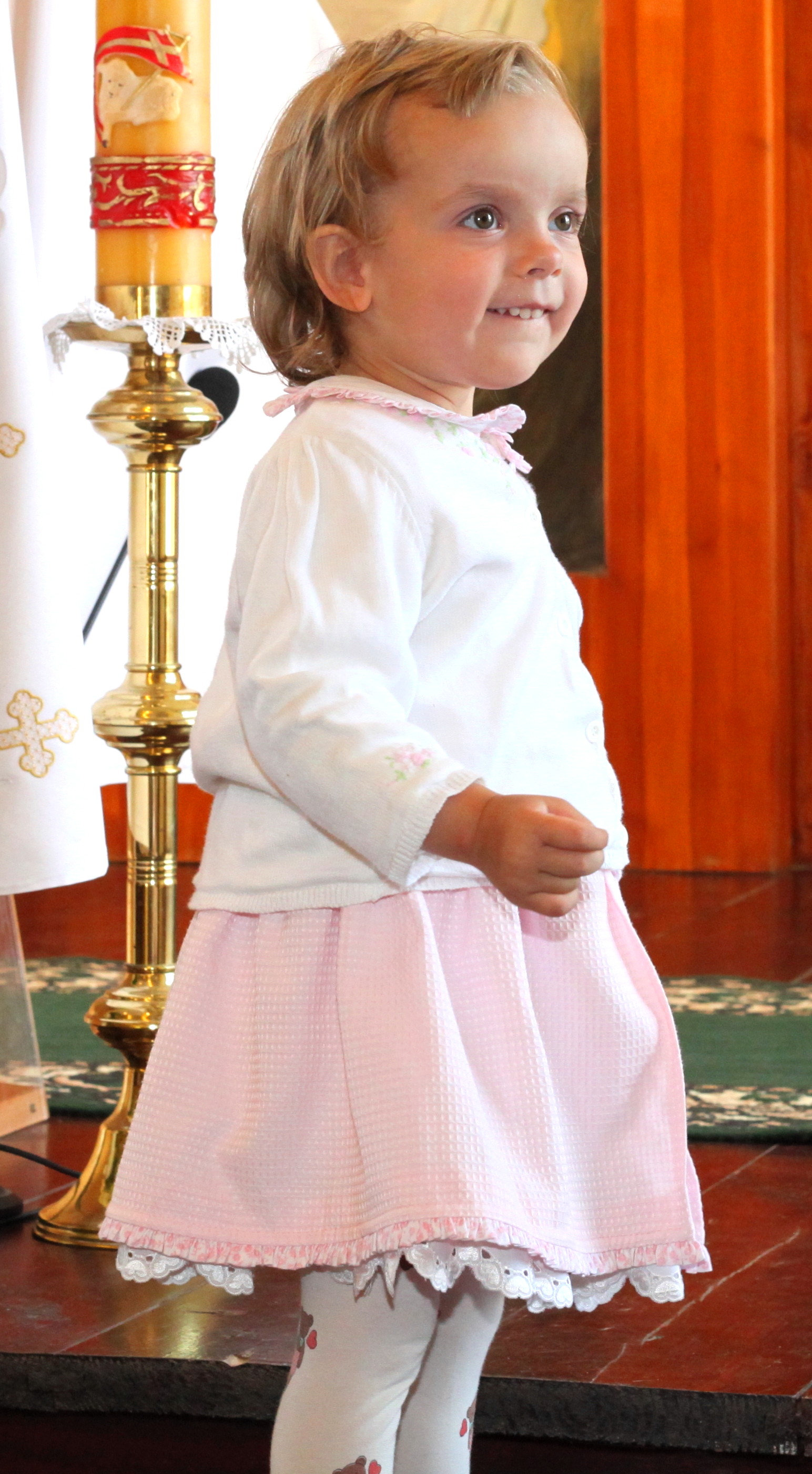 a cute Catholic baby girl in a Church
