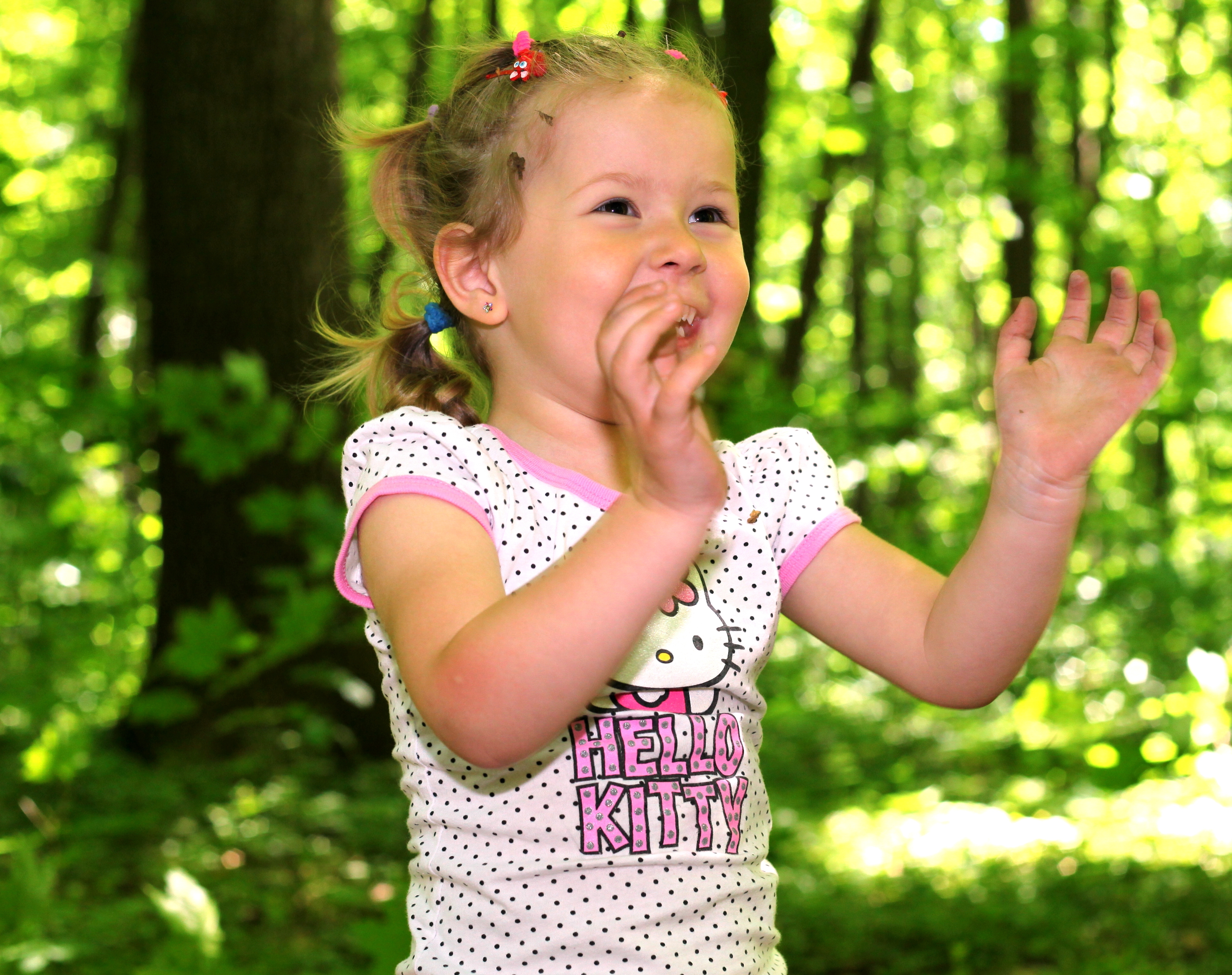 a cute Catholic kid girl in a forest photographed in May 2013, image 2/2