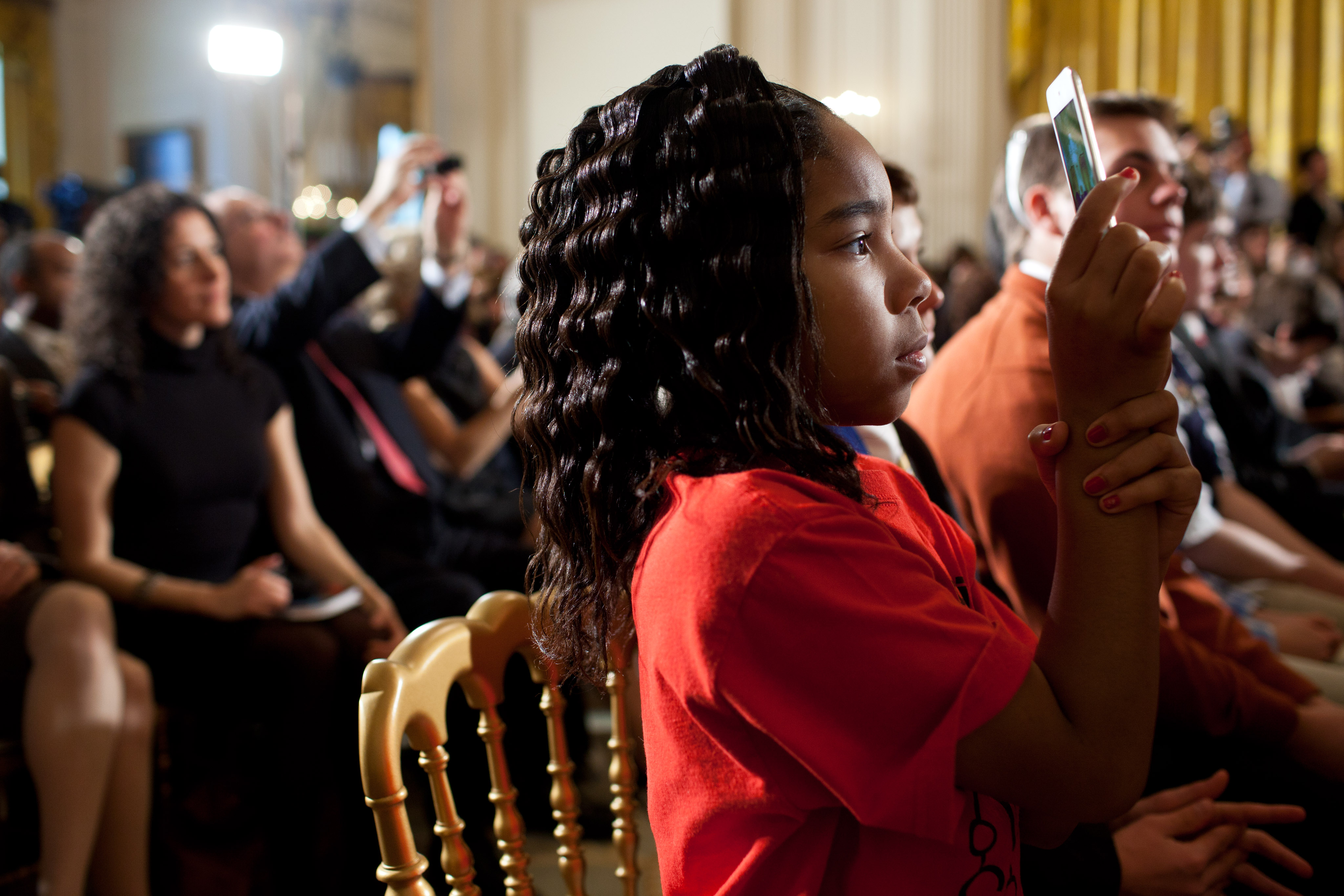 A student takes a picture of President Barack Obama, 2012
