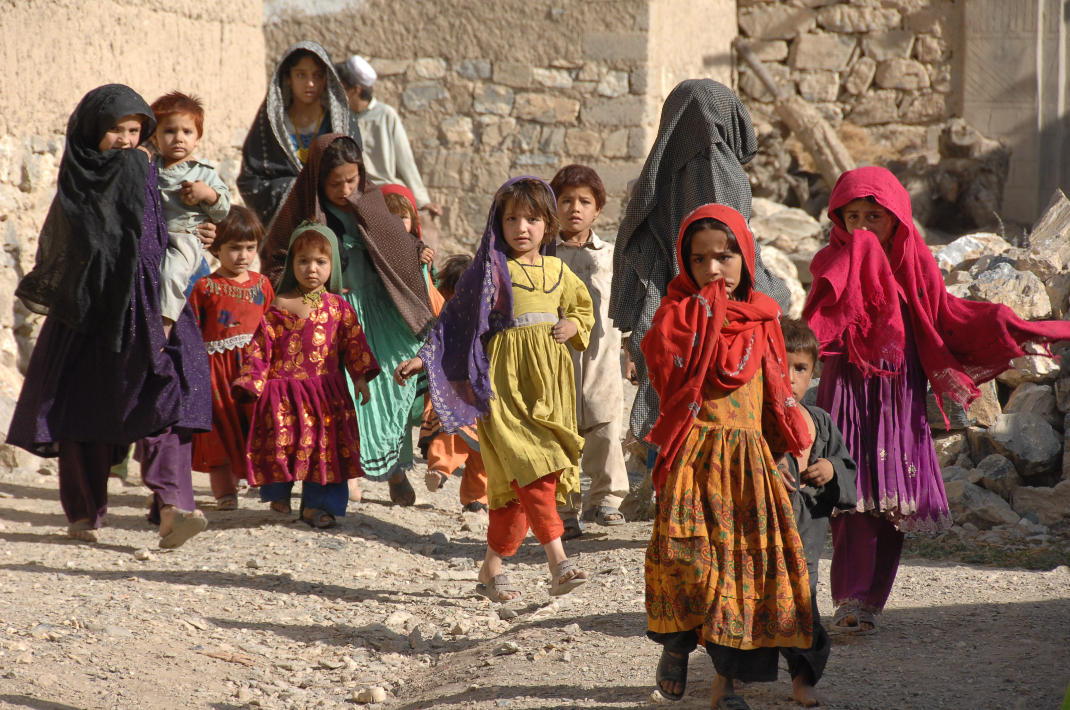 Afghan children walk towards a medical civic assistance program site in Chamkani, Afghanistan, Aug. 18, 2007 070818-A-DM197-015