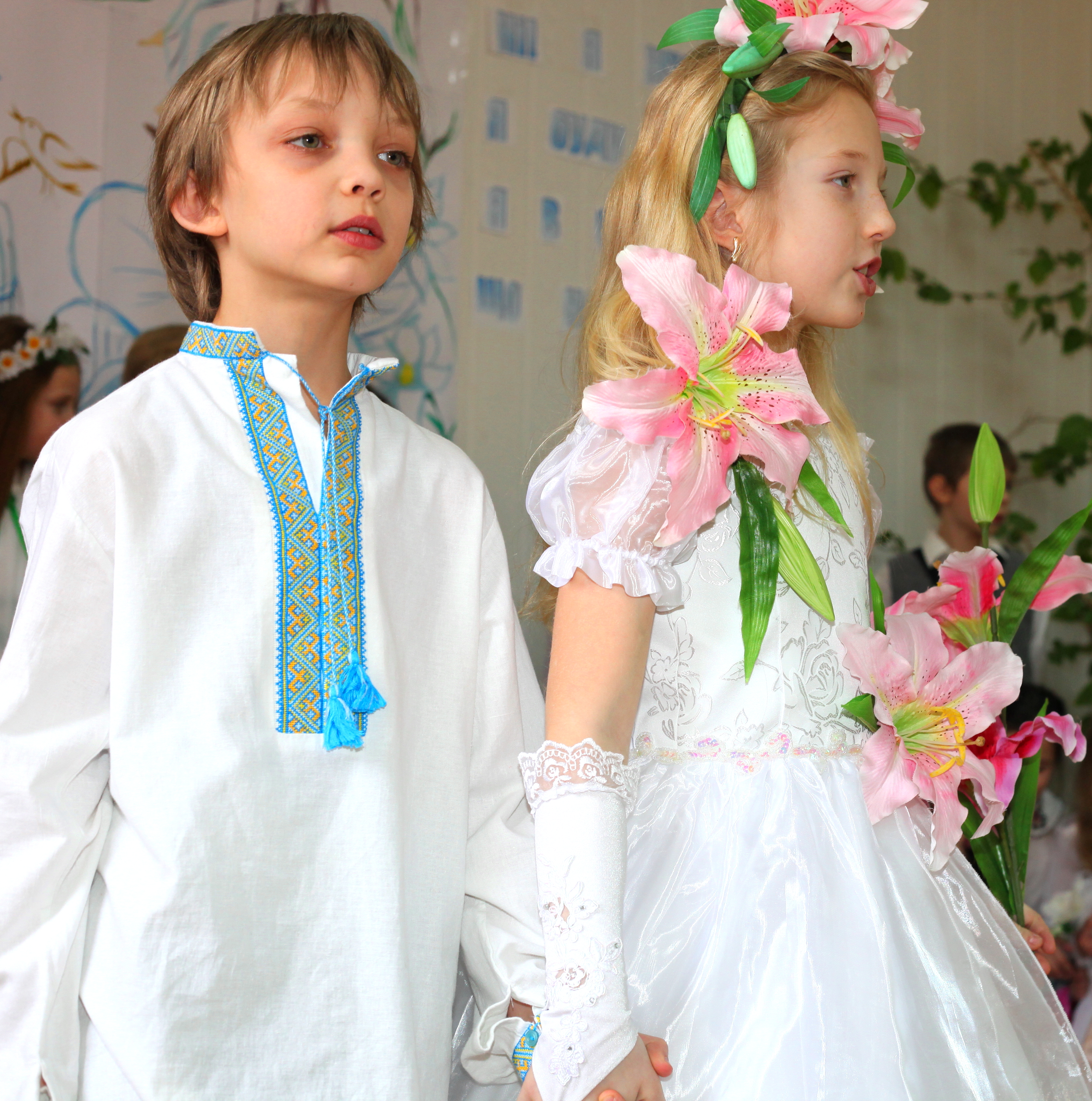 a boy and a girl performing in a school