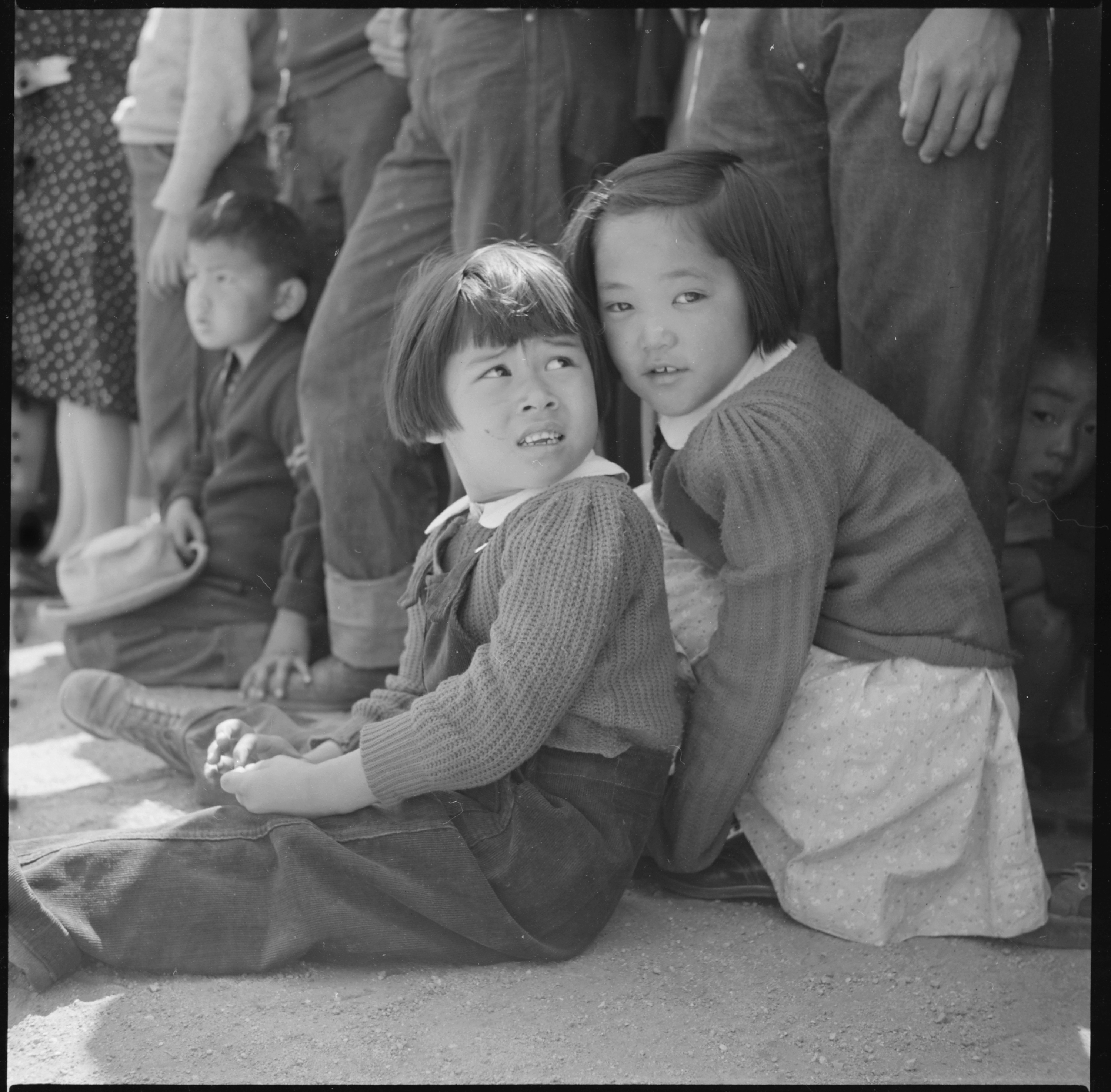 Manzanar Relocation Center, Manzanar, California. Little evacuees of Japanese descent watch Memoria . . . - NARA - 538542