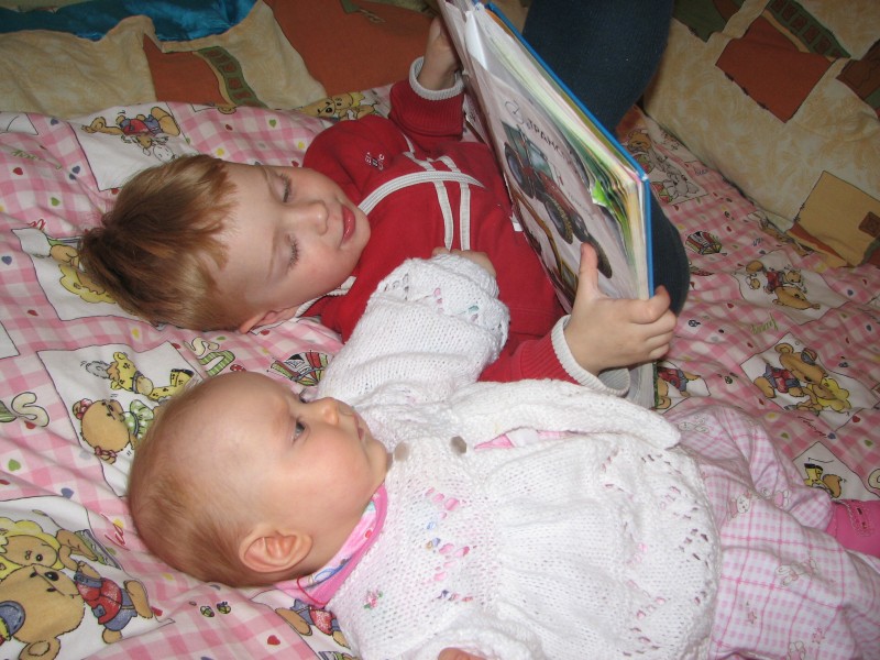 Babies reading one of their first books.
