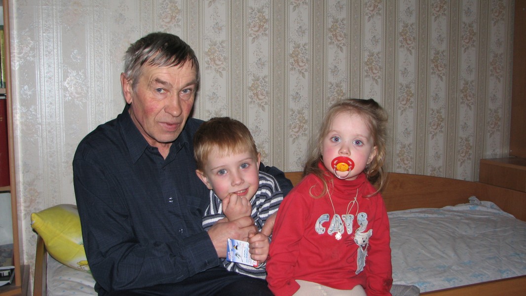 A grandfather with his small grandchildren