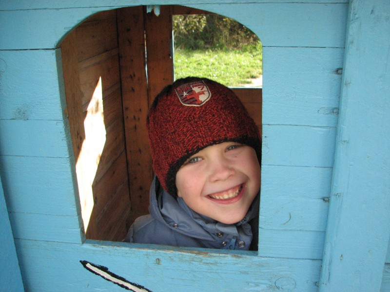 A smiling boy in a hut, picture 2
