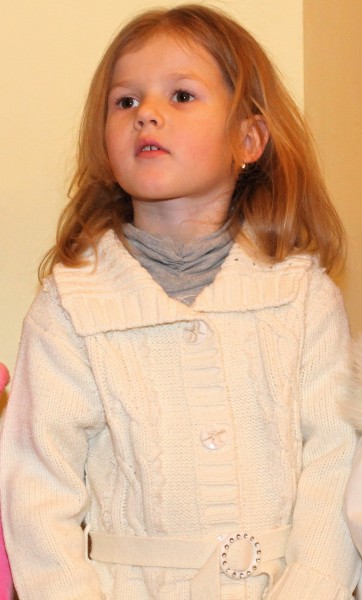 a beautiful blond Catholic child girl in a Catholic kindergarten