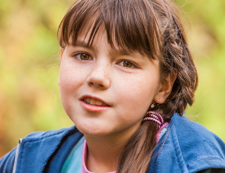 a cute brunette Catholic child girl photographed in May 2014, picture 4/5