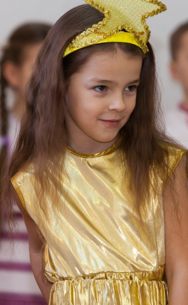 a cute young girl performing in school in December 2013, picture 3/14