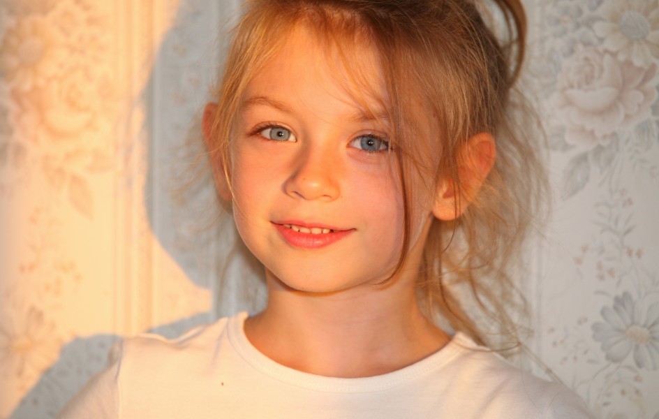a cute fair-haired Catholic child girl photographed in July 2013