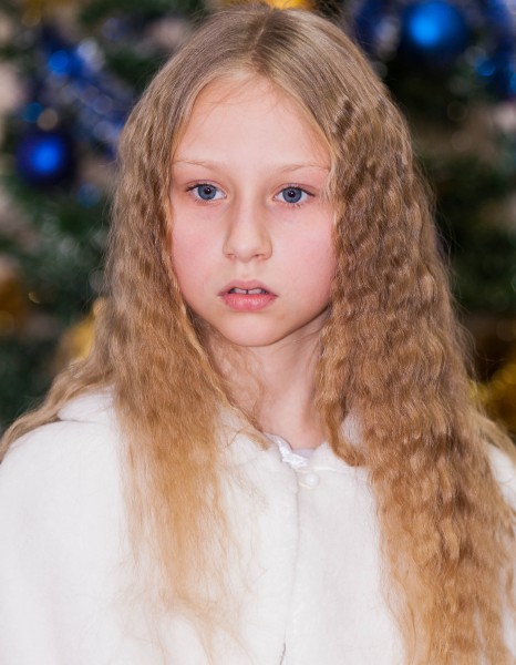 a young blond pretty schoolgirl photographed in December 2013, picture 2/6