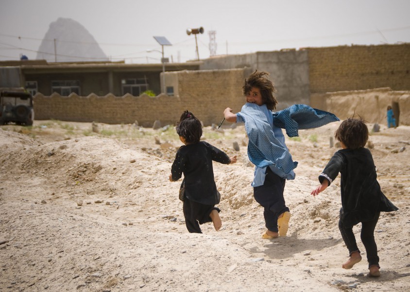 Afghan children play near U.S. military on patrol (4665782053)