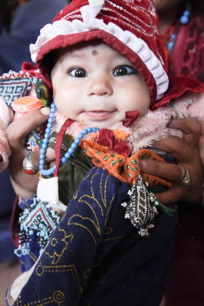 An Afghan woman holds up baby boy for the camera, during a women medical engagement at Operation Spartan Stork on Dasht Camp, Kandahar province, Afghanistan, Oct. 26, 2011 111026-A-VB845-015