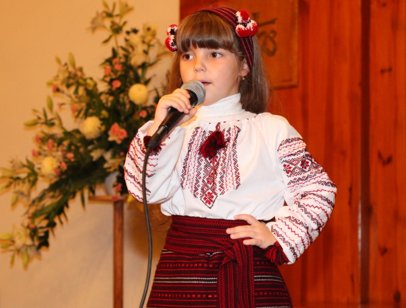 an amazingly cute brunette Catholic child girl performing in a Catholic kindergarten, photo 7