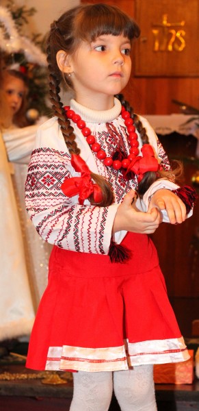 an amazingly beautiful brunette Catholic child girl performing in the Nativity scene, photo 6
