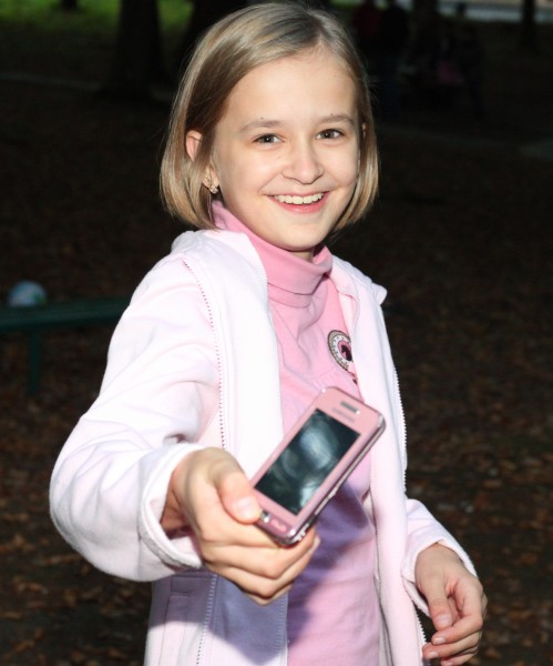 an appealing young smiling Catholic girl in a park, picture 2