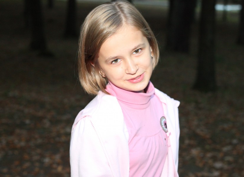 an appealing young smiling Catholic child girl in a park, picture 4