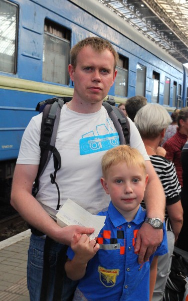 A father and son at a train station