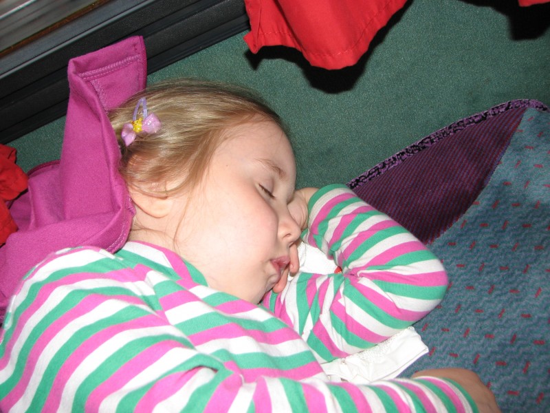 A 5-year old girl sleeping in a bus
