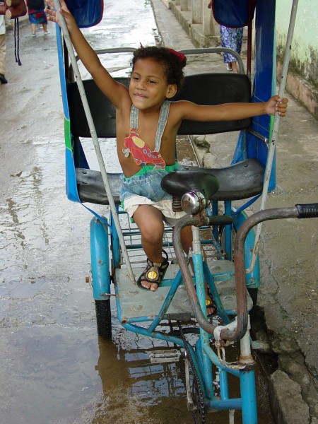 Girl Plays in a Pedicab - Baracoa - Cuba
