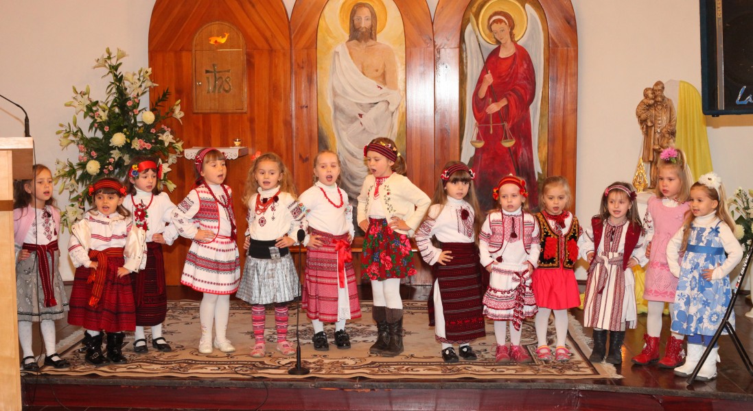 thirteen child girls performing in a Catholic kindergarten