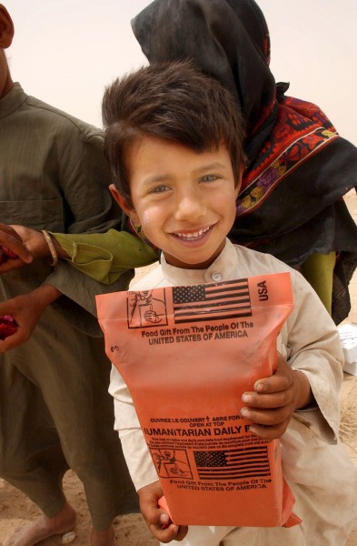 US Navy 030408-N-5362A-001 An Iraqi boy holds a humanitarian food ration given to him by U.S. Army soldiers during an effort to distribute food and water to Iraqi citizens in need