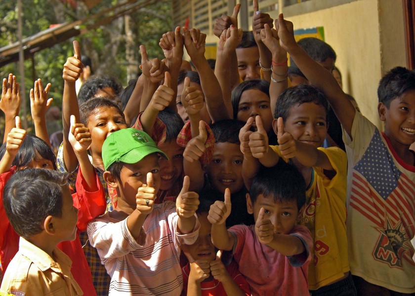 US Navy 050117-N-9951E-190 Indonesian children give a thumbs-up in celebration of relief aid near the town of Glebruk, one of the many coastal towns on the island of Sumatra, Indonesia hit by the Tsunami that struck South East