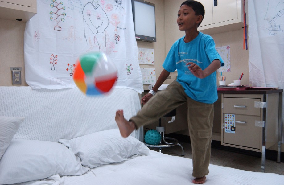 US Navy 050215-N-6504N-001 An Indonesian boy plays with a beach ball in the playroom aboard the Military Sealift Command (MSC) hospital ship USNS Mercy (T-AH 19)