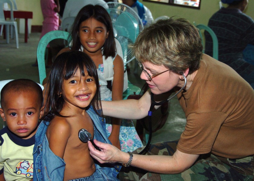 US Navy 060528-N-8391L-103 U.S. Air Force Major Valerie Clegg evaluates a child as part of a medical assistance mission deployed from the U.S. Navy hospital ship USNS Mercy (T-AH 19)