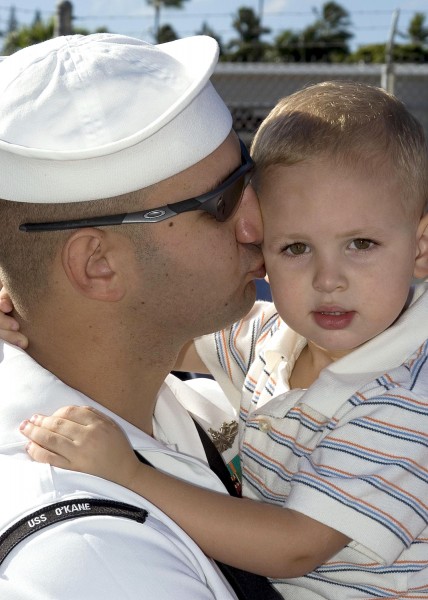 US Navy 070126-N-1280S-007 Fire Controlman 1st Class Kris McGuire, stationed aboard guided missile destroyer USS O'Kane (DDG 77), kisses his son goodbye as he prepares to get underway