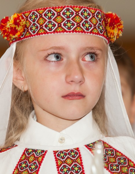 a young blond girl with crying eyes photographed in May 2014, image 1/2