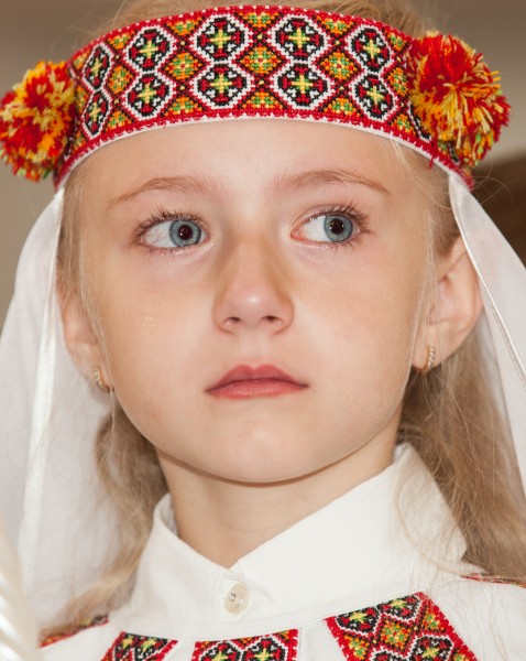 a young blond girl with crying eyes photographed in May 2014, image 2/2