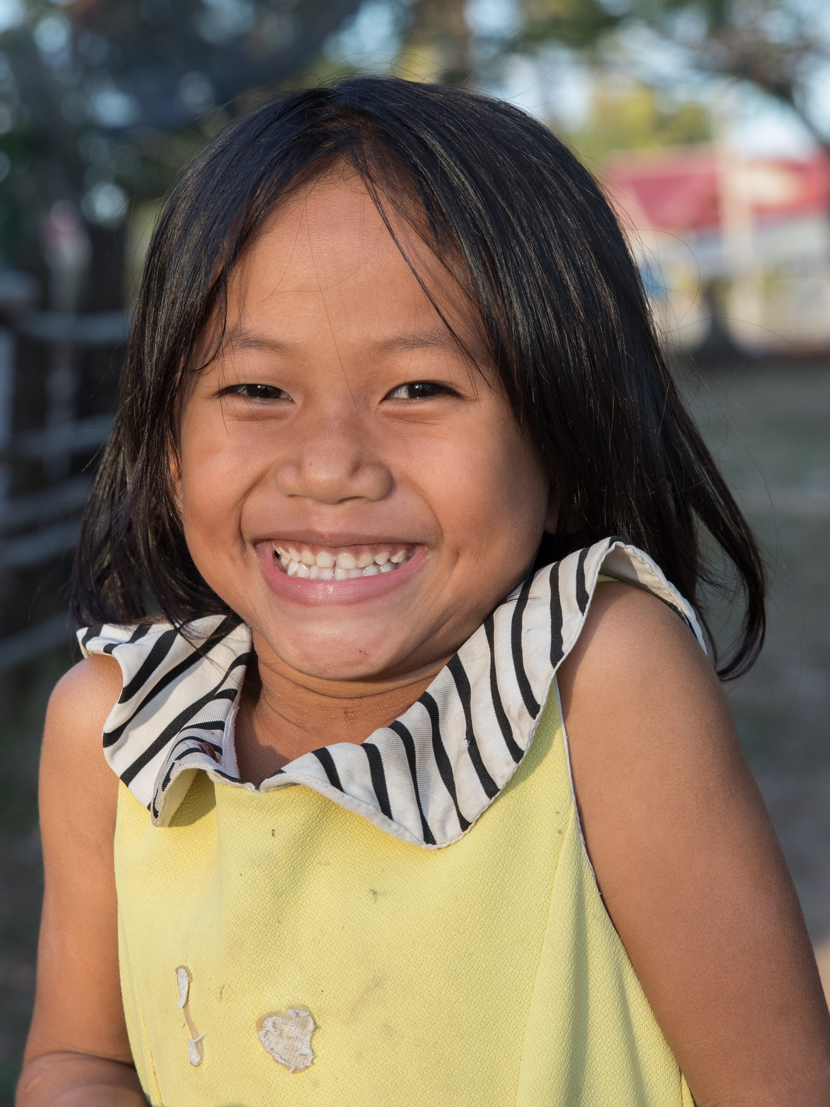 Smiling young girl with yellow shirt