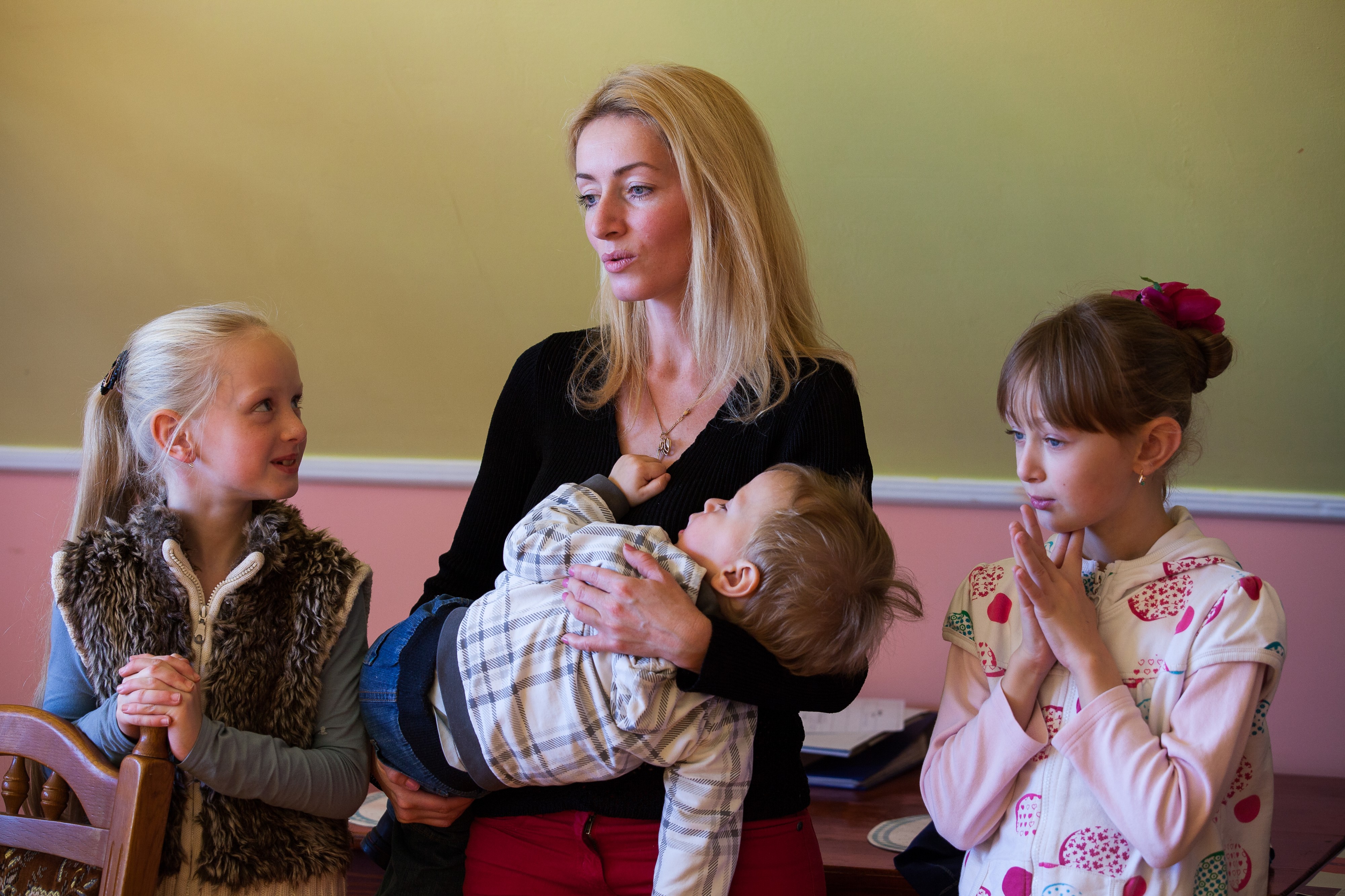 a young Catholic mother with her three children photographed in October 2013