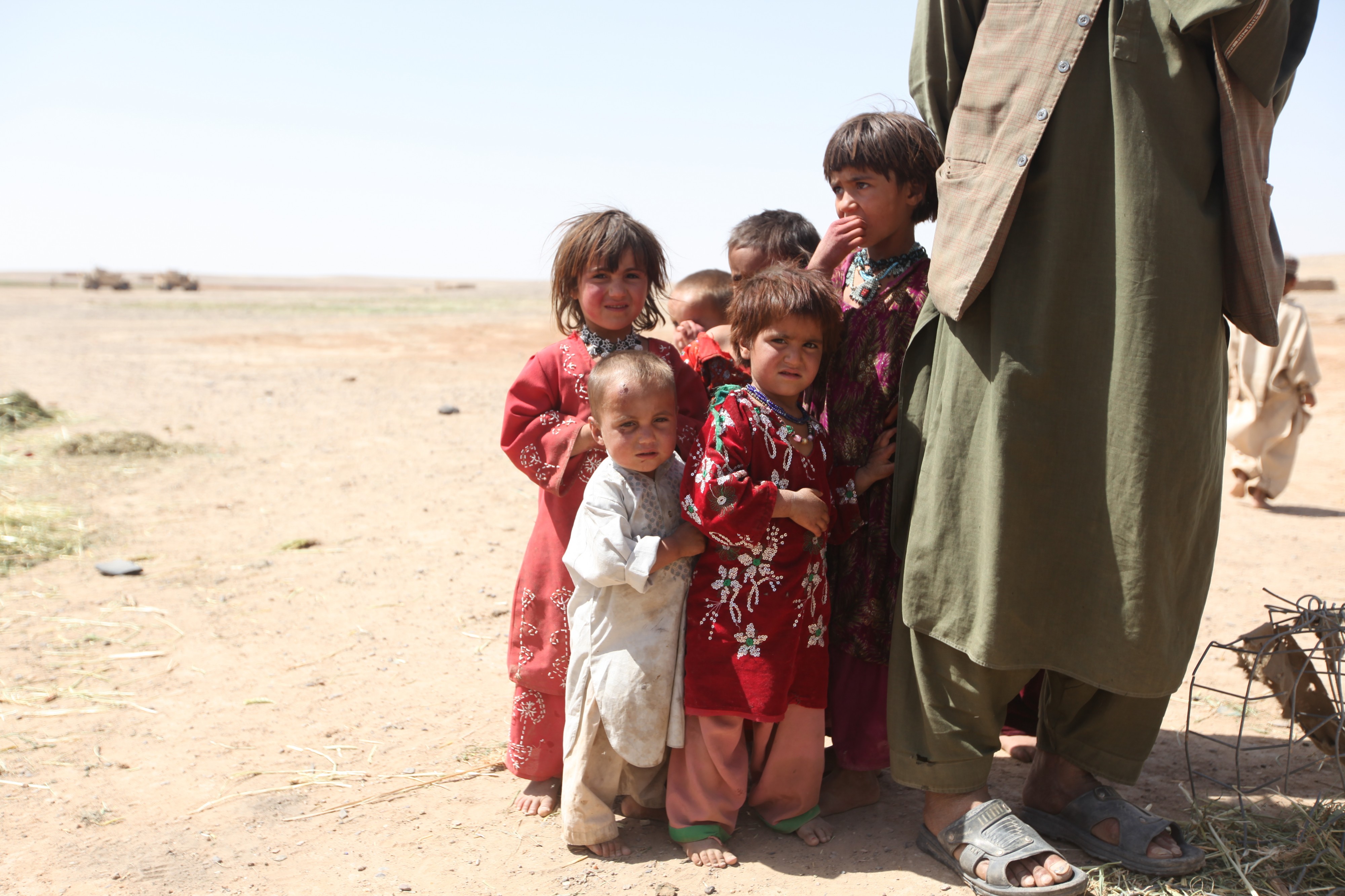Afghan children stand next to their father (4518838314)