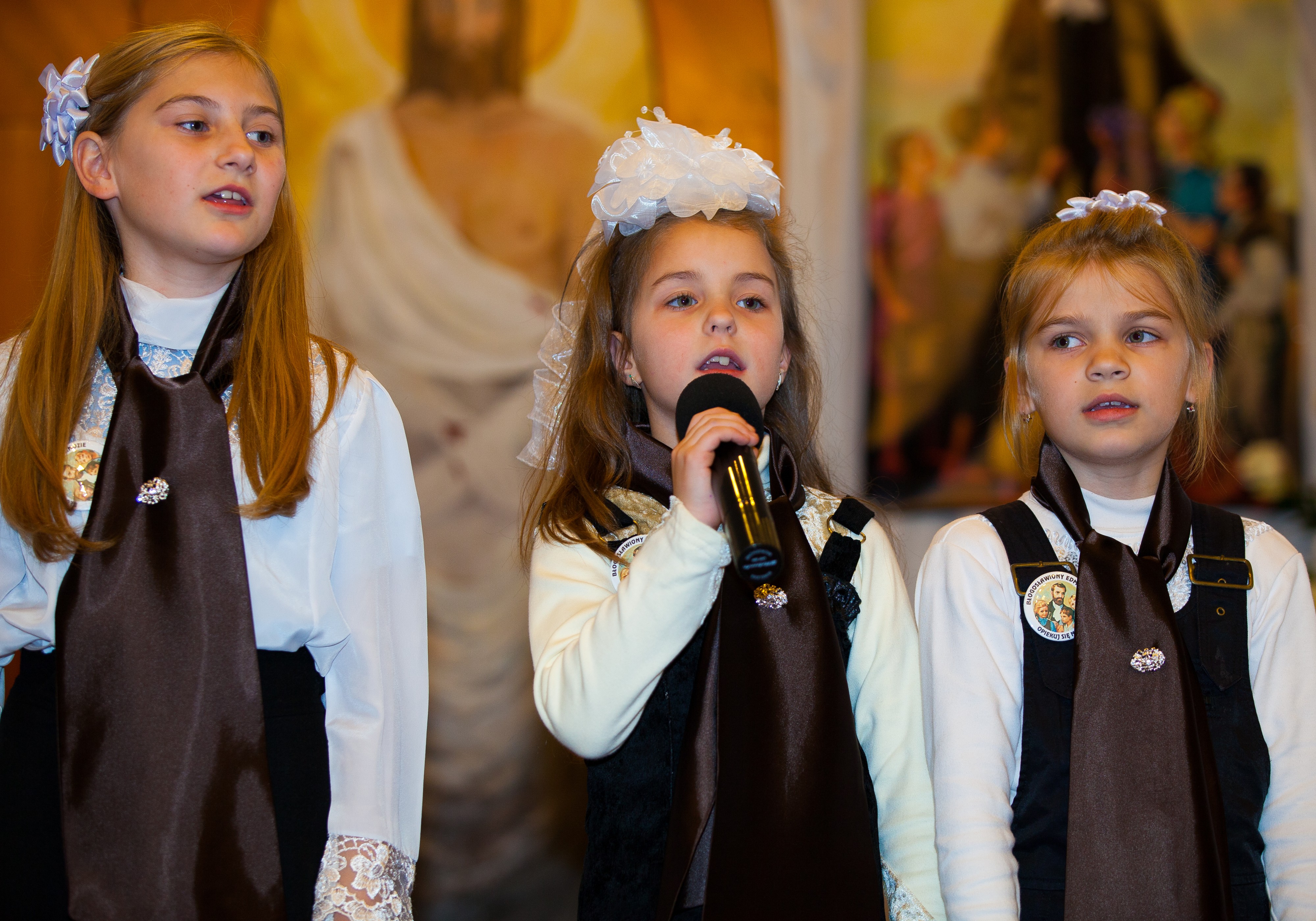 three young girls performing in a Catholic chapel in November 2013