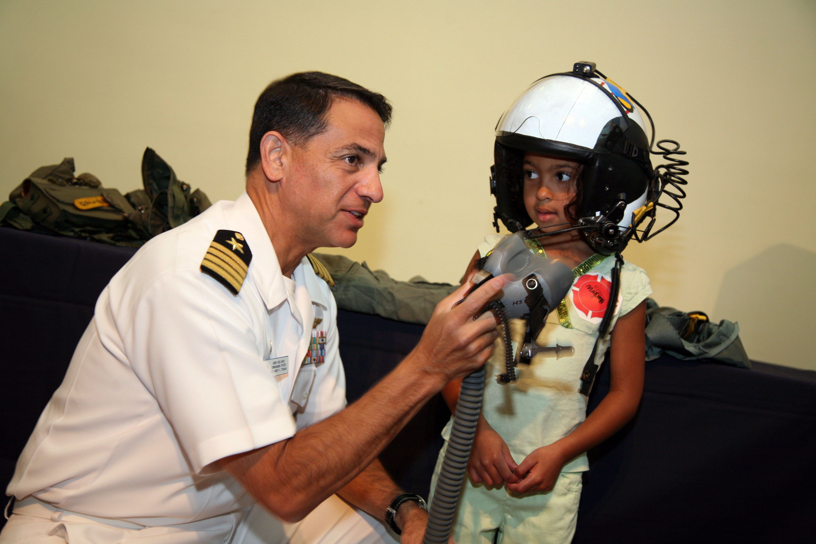 US Navy 070829-N-3271W-002 Capt. Herman Shelanski, commanding officer of USS Harry S. Truman, suits up a young pilot at the St. Louis Science Center