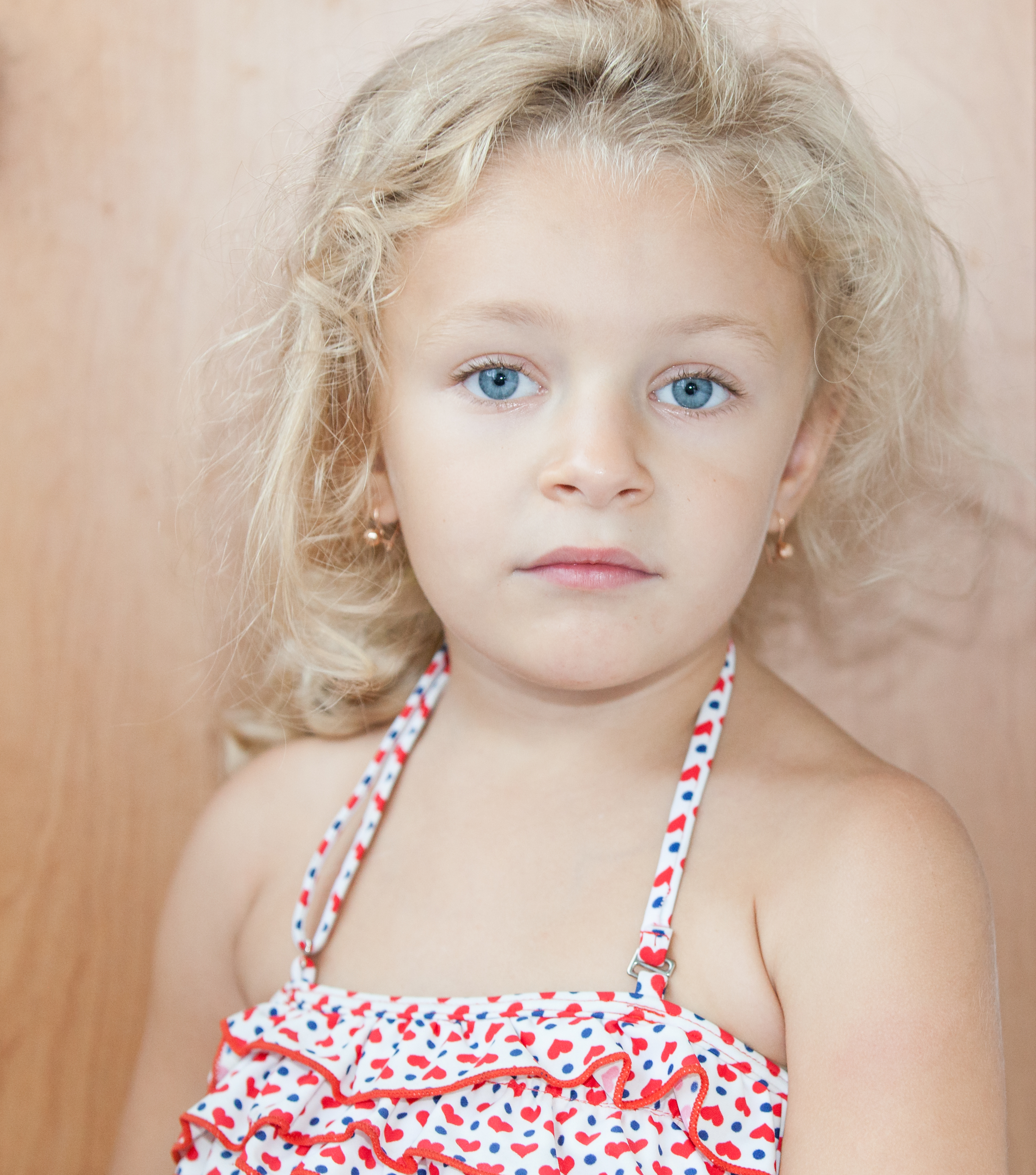 a cute blond blue-eyed child girl photographed in August 2014, picture 2