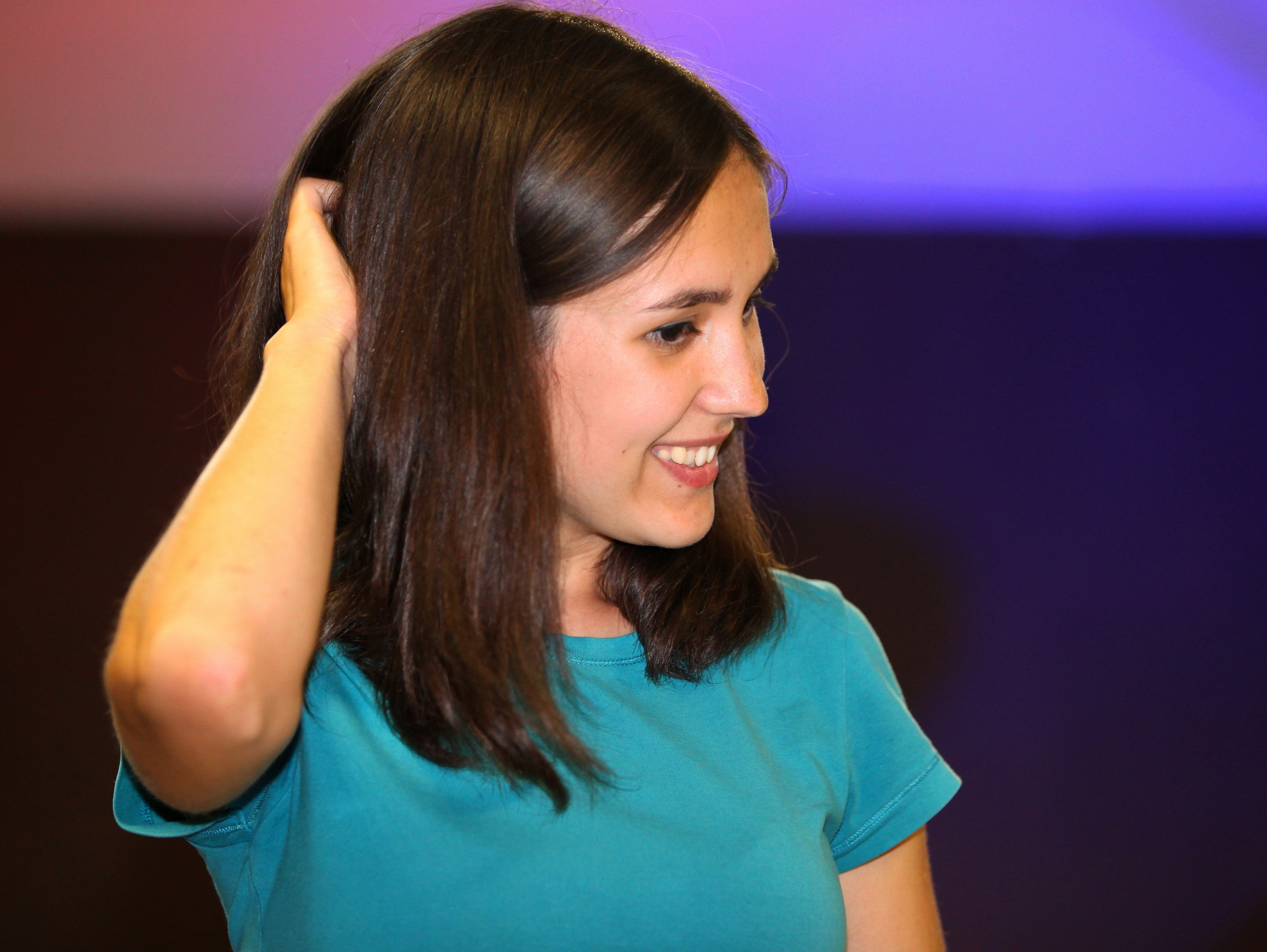 a cute brunette girl scratching her head at a Christian protestant gathering in July 2013, picture 3/5