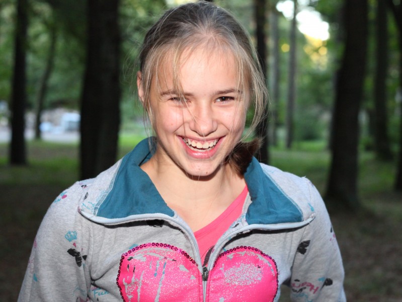 a sweet beautiful appealing smiling Catholic girl in a park, picture 11