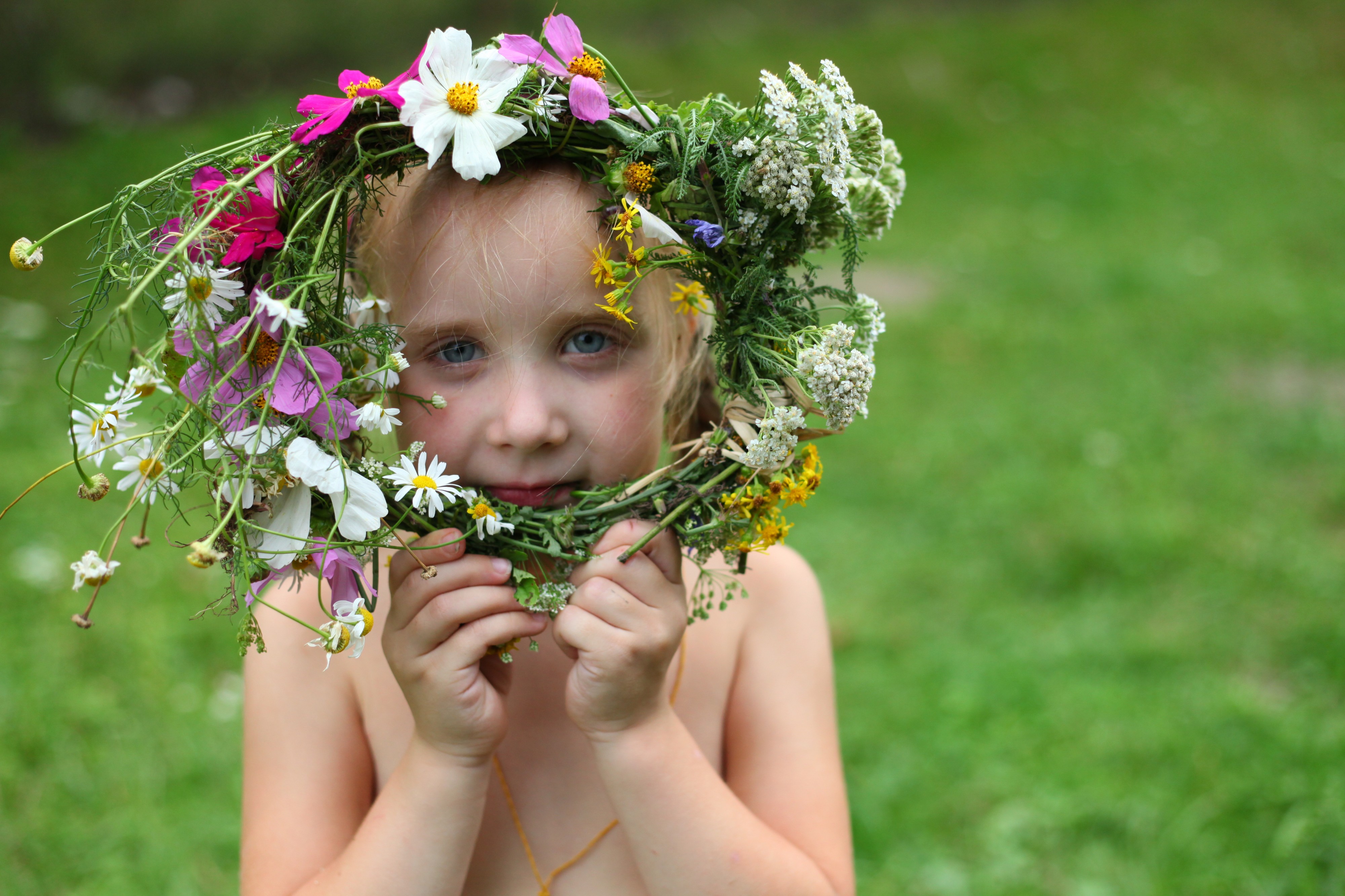 a child girl with a wreath of flowers