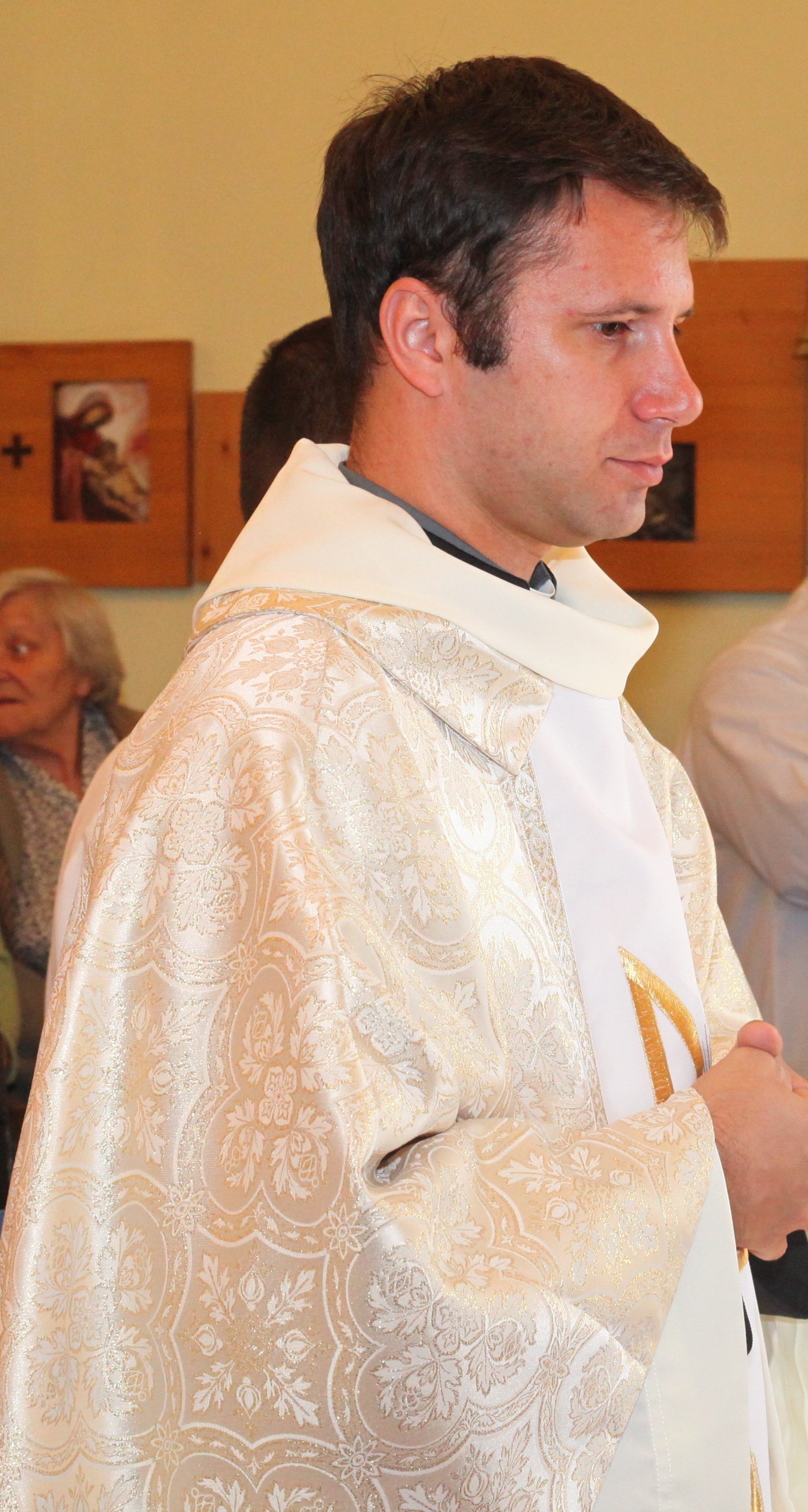 a young Catholic priest in a Church, photo 2