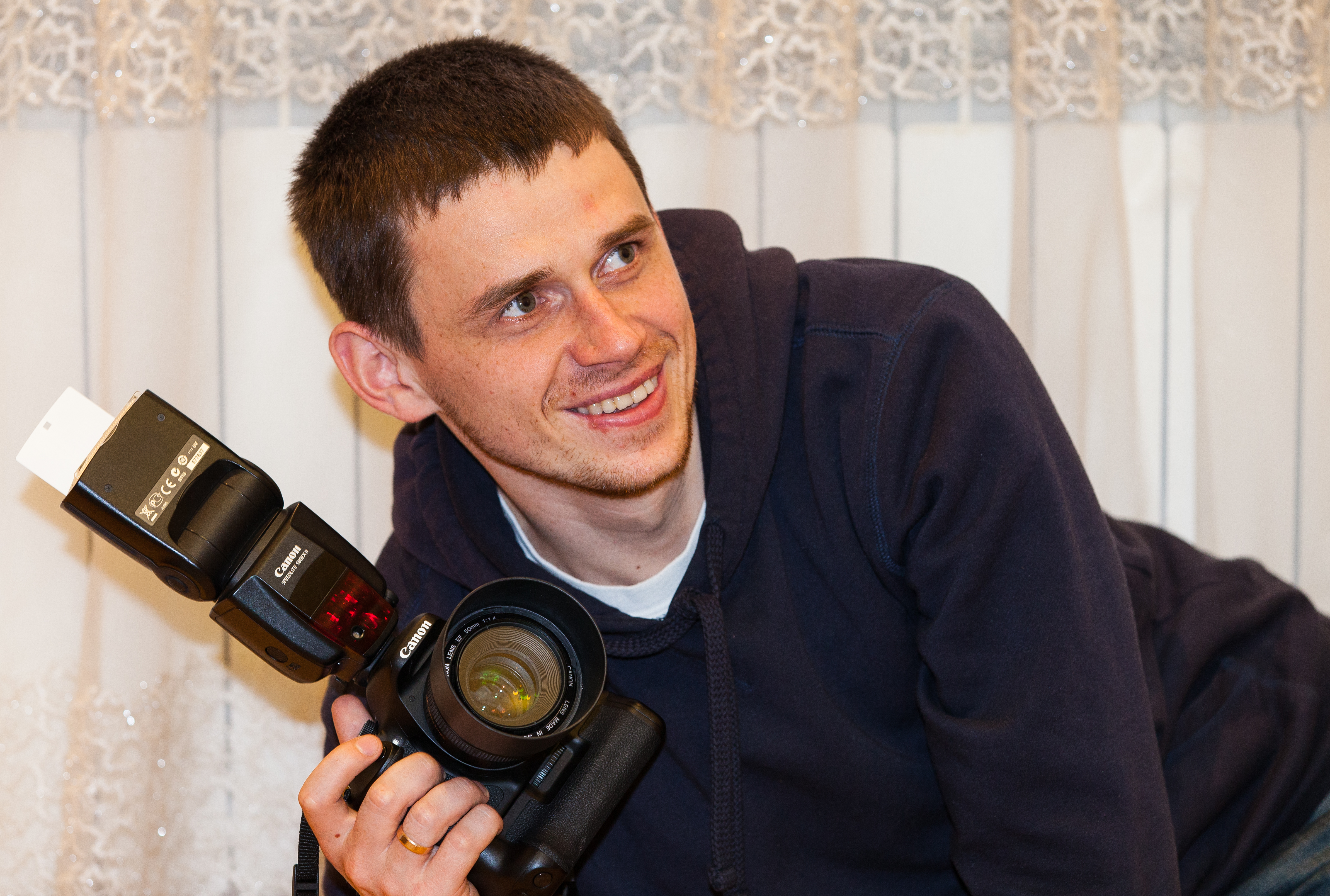 a photographer holding his Canon camera in April 2014